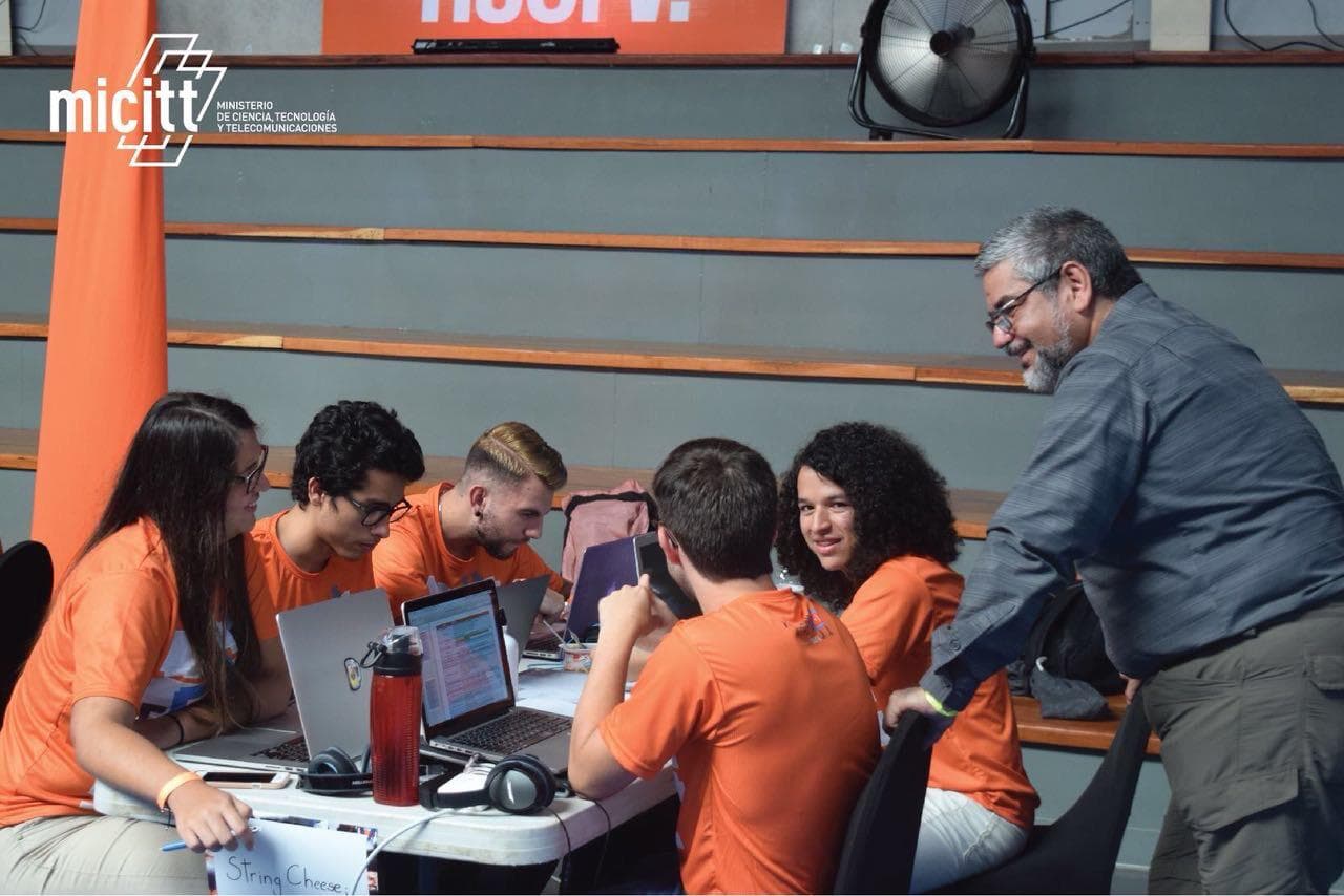 Team String Cheese heads-down coding at the Programathon 2017 while a mentor looks on