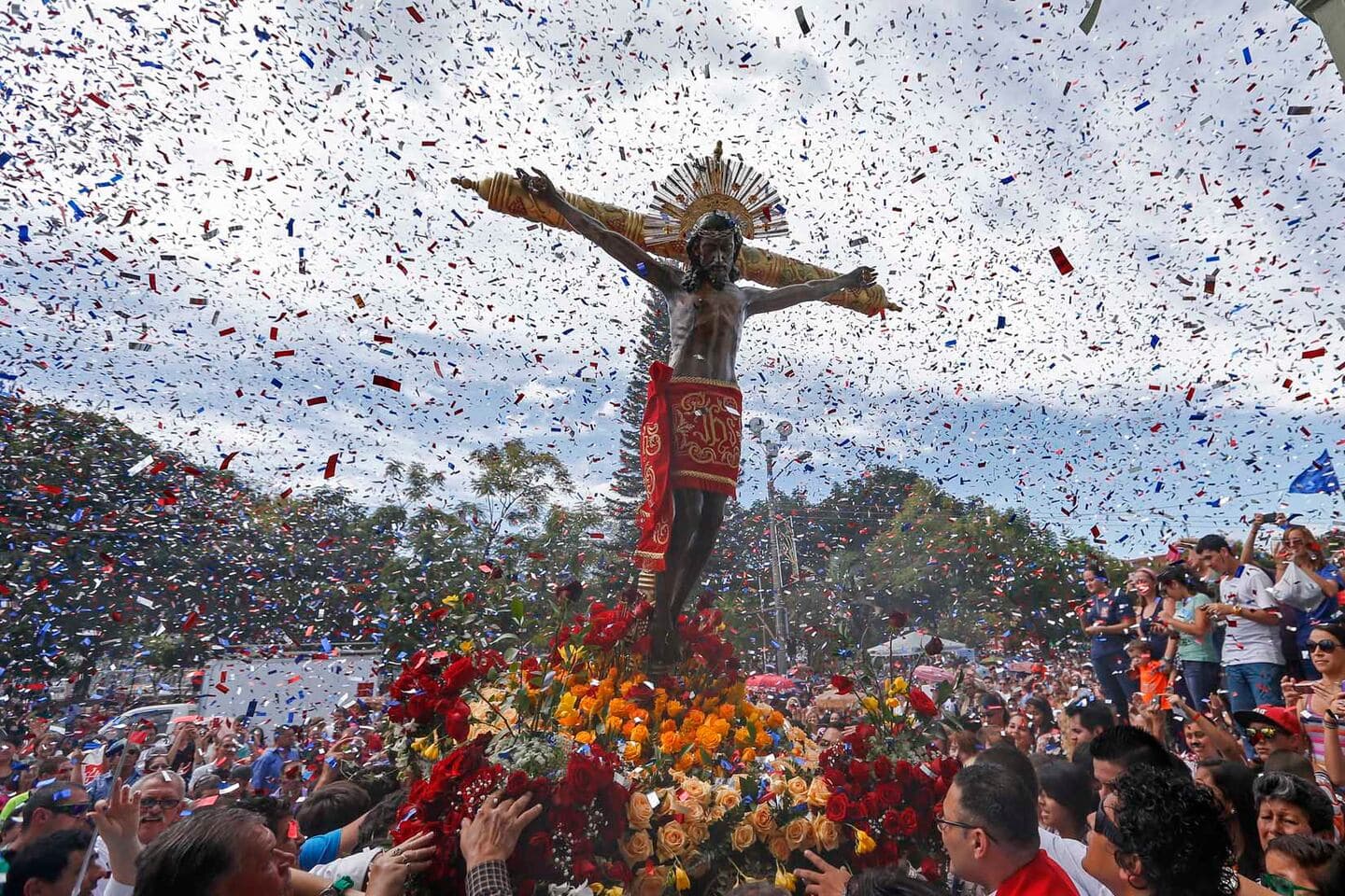 The Santo Cristo de Esquipulas carried over a sea of roses under confetti during the 15 January procession in Alajuelita